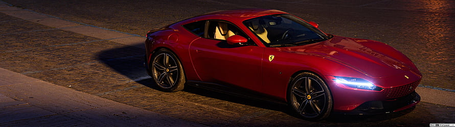Red Ferrari Roma Coupe Parked on Cobblestone Street at Night with Headlights On HD wallpaper