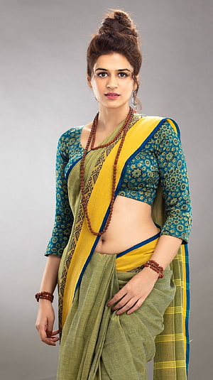 Shraddha Das in Traditional Green and Yellow Saree with Turmeric Bead Necklace HD phone wallpaper