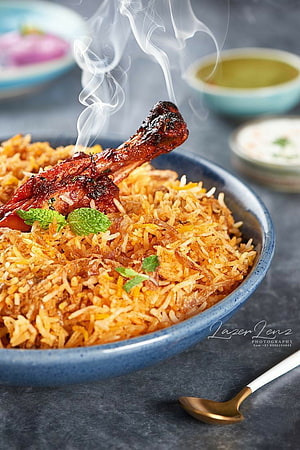 Steaming Mutton Biryani with Mint Garnish in a Blue Ceramic Bowl HD phone wallpaper