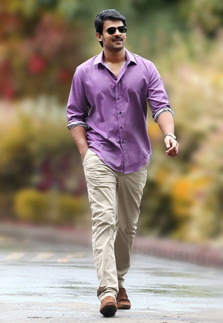 Prabhas in a purple shirt and beige trousers walking outdoors with sunglasses HD phone wallpaper