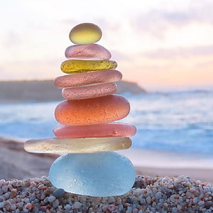 Colorful Sea Glass Zen Stack on a Beach at Sunset HD phone wallpaper