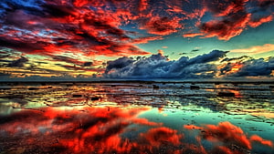 Vivid Crimson Clouds Reflected in Shallow Tidal Pools at Sunset HD wallpaper