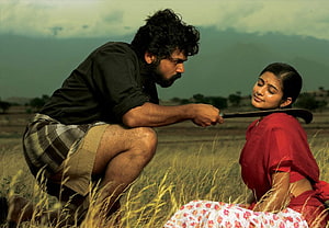 Paruthiveeran Film Still: Man with Sickle in Rural Field HD wallpaper