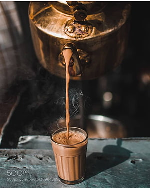 Steaming Indian Chai Pouring From Traditional Brass Kettle Into Glass Cup HD phone wallpaper