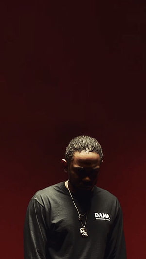 Kendrick Lamar in Dramatic Low-Key Portrait Against Deep Red Background HD phone wallpaper