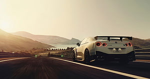 White Nissan GT-R Nismo R35 Cruising on a Scenic Mountain Highway at Sunset HD wallpaper