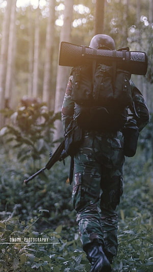 Kopassus Soldier in Camouflage Gear Walking Through Dense Jungle Forest HD phone wallpaper