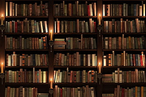 Cozy Candlelit Library Wall With Antique Leather Books And Warm Wooden Shelves HD wallpaper