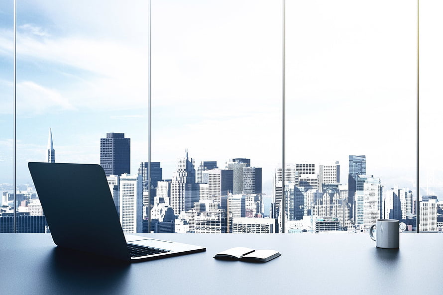 Modern Office Desk with Laptop and Notebook Overlooking City Skyline Through Floor-to-Ceiling Windows HD wallpaper