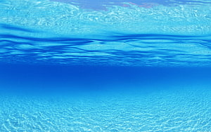 Calm Underwater Ocean Surface with Sunlit Ripples and Deep Blue Water HD wallpaper