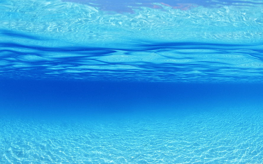Calm Underwater Ocean Surface with Sunlit Ripples and Deep Blue Water HD wallpaper