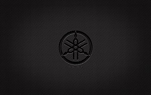 Yamaha Tuning Fork Emblem on Dark Carbon Fiber Texture HD wallpaper