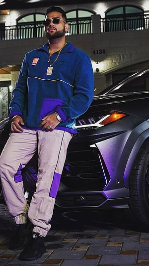 Karan Aujla in Adidas Track Suit Leaning Against Matte Black Lamborghini at Night HD phone wallpaper