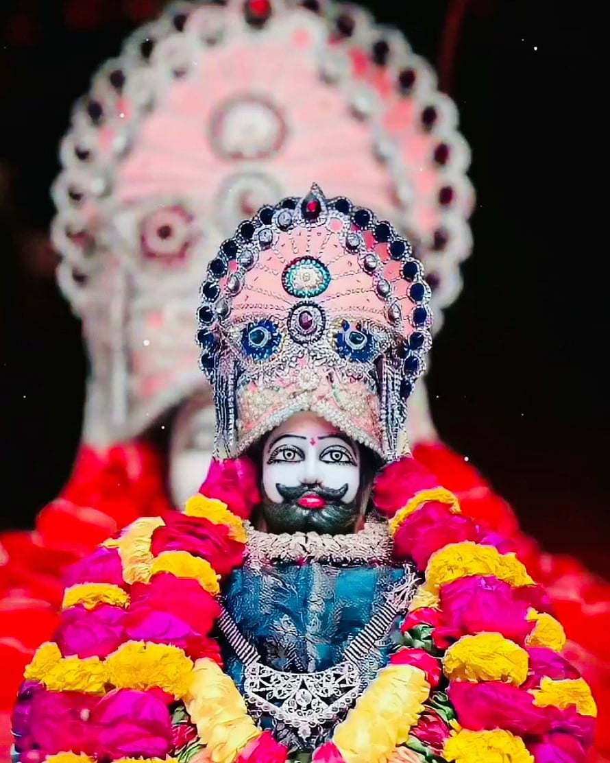 Ornate Ramapir Murti Adorned With Vibrant Marigold And Rose Flower Garlands HD phone wallpaper