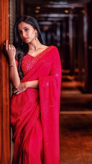 Srinidhi Shetty in a vibrant red embroidered saree with elegant jewelry and long dark hair HD phone wallpaper