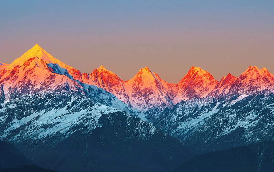 Snow-Capped Mountain Range Bathed in Golden Sunrise Light HD wallpaper