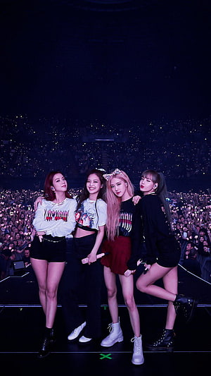 Blackpink K-pop Group Performing on Stage at a Large Concert with Glowing Audience HD phone wallpaper