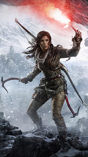 Lara Croft from Rise of the Tomb Raider holding a torch and climbing axe in a snowy mountain landscape HD phone wallpaper