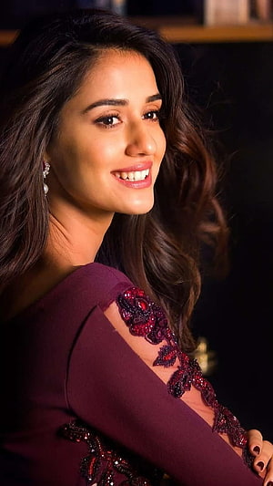 Disha Patani in an elegant maroon embroidered gown with a warm smile HD phone wallpaper
