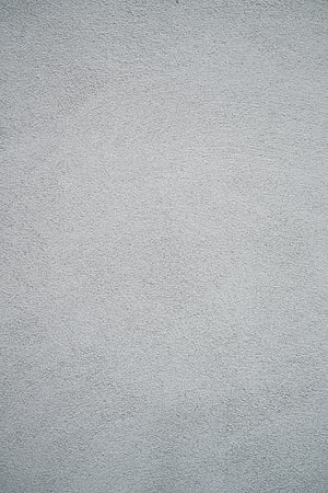 Minimalist Light Gray Plaster Wall Texture with Subtle Surface Grain and Matte Finish HD phone wallpaper