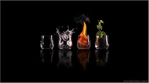 Four Elements Concept: Earth, Water, Fire, and Air in Glass Vessels on Black Background HD wallpaper
