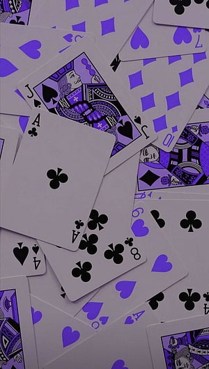 Scattered Purple Playing Cards with Black Suits and Face Card Illustrations HD phone wallpaper