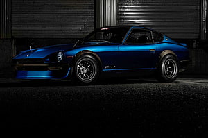 1973 Datsun 240Z Classic Blue Sports Car in Dark Industrial Garage Setting HD wallpaper