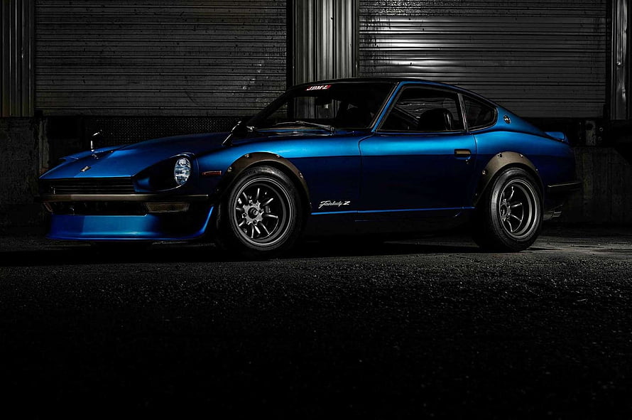 1973 Datsun 240Z Classic Blue Sports Car in Dark Industrial Garage Setting HD wallpaper