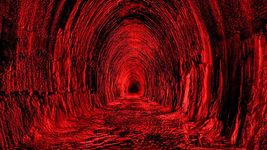 Eerie Red-Lit Stone Tunnel With Deep Perspective And Dark Atmosphere HD wallpaper