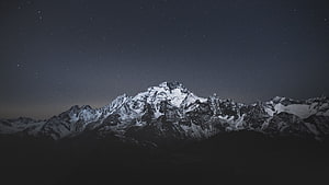 Snow-Capped Mountain Range Under a Starry Night Sky HD wallpaper