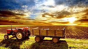 Vintage Red Tractor and Wooden Farm Trailer in a Plowed Field at Golden Sunset HD wallpaper