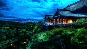 Traditional Japanese Temple Perched on a Hillside Overlooking Kyoto at Dusk HD wallpaper