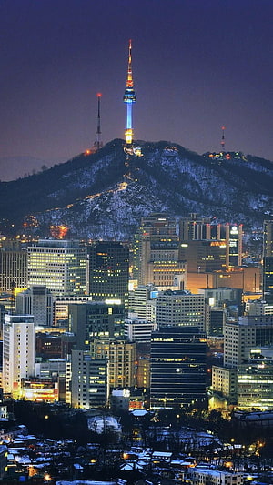 N Seoul Tower Illuminated at Night Over Snowy Namsan Hill and Seoul Cityscape HD phone wallpaper
