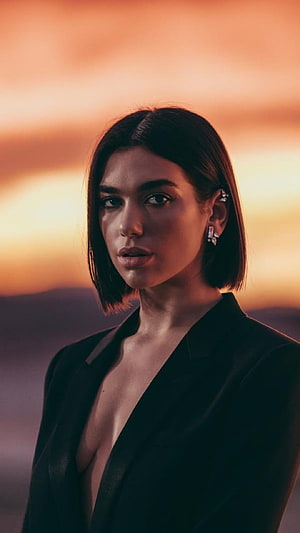 Dua Lipa Portrait in Black Blazer Against Warm Sunset Sky HD phone wallpaper
