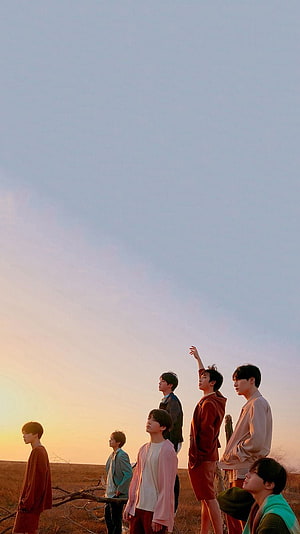 BTS Members Standing in a Golden Desert Landscape at Sunset HD phone wallpaper