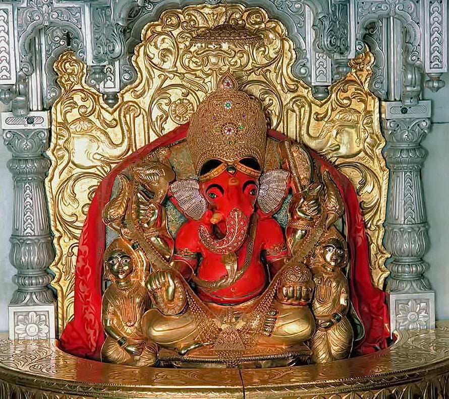 Siddhivinayak Ganesha Murti with Ornate Gold Carvings and Red Drapery HD wallpaper