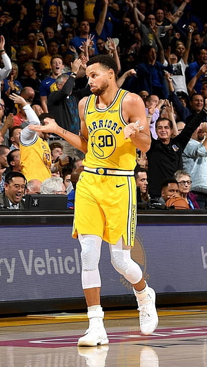 Stephen Curry in Golden State Warriors yellow jersey celebrating on the basketball court HD phone wallpaper