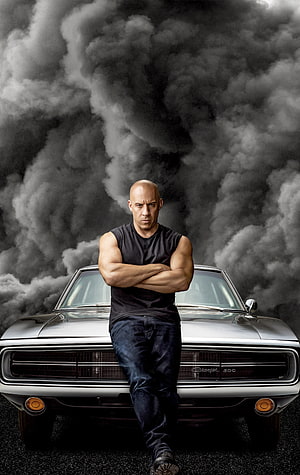 Vin Diesel Leaning on Classic Dodge Charger Against Dramatic Smoke Background HD phone wallpaper