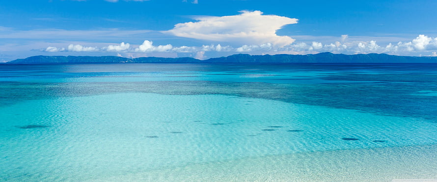 Tropical Lagoon Panorama With Distant Mountains And Turquoise Shallow Waters HD wallpaper