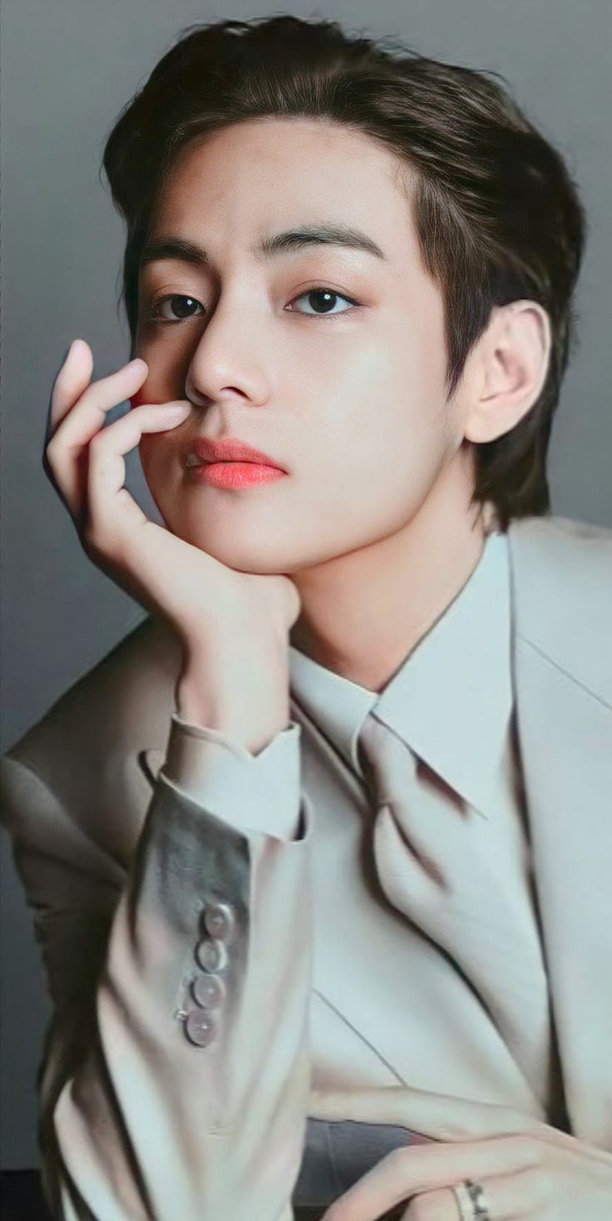 Kim Taehyung in a cream suit with hand resting on chin, soft studio portrait HD phone wallpaper