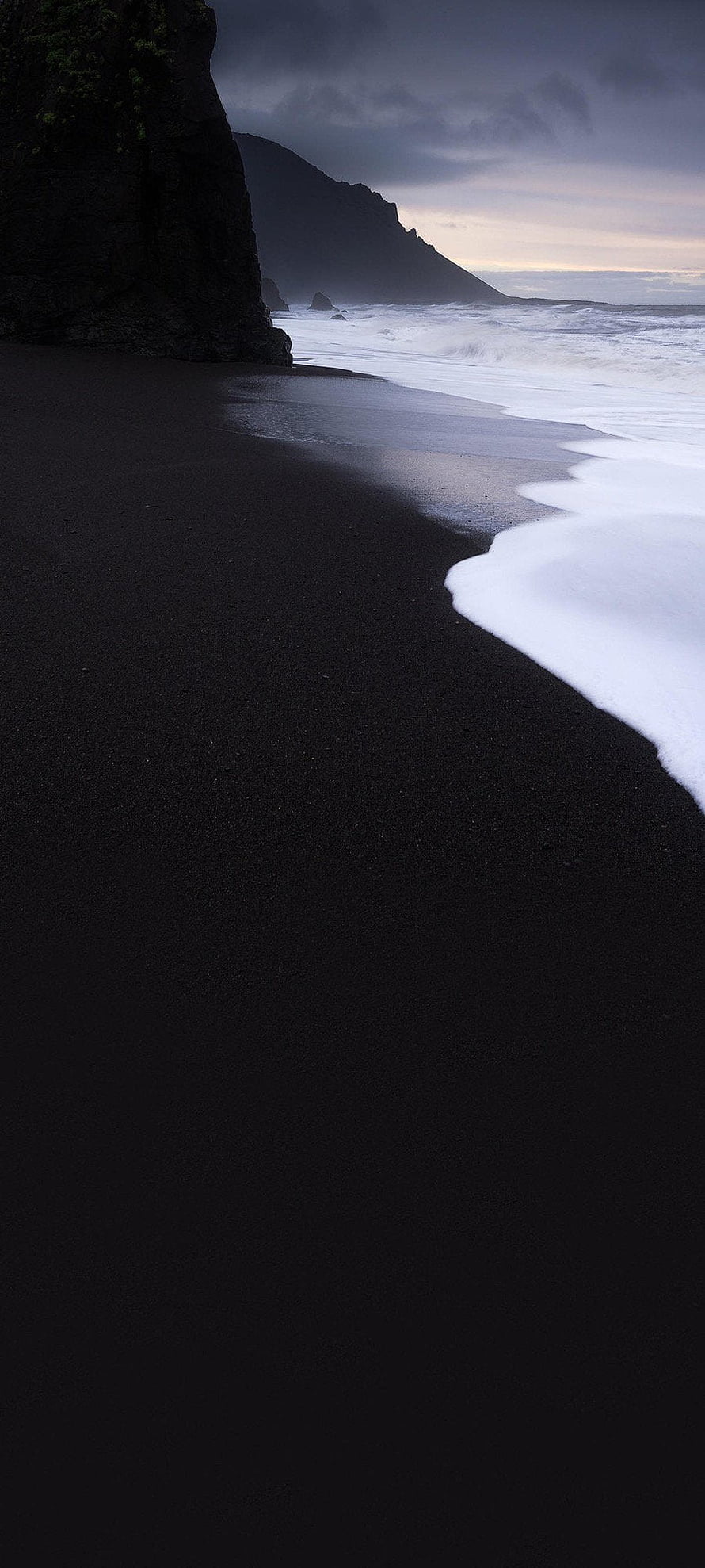 Moody Black Sand Beach with Dark Cliffs and Foaming Ocean Waves at Dusk HD phone wallpaper