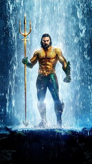 Aquaman standing in heavy rain holding golden trident with armored suit and glowing blue background HD phone wallpaper