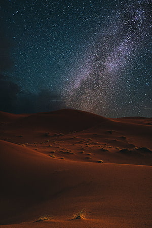 Milky Way Galaxy Arching Over Red Desert Dunes Under a Starry Night Sky HD phone wallpaper
