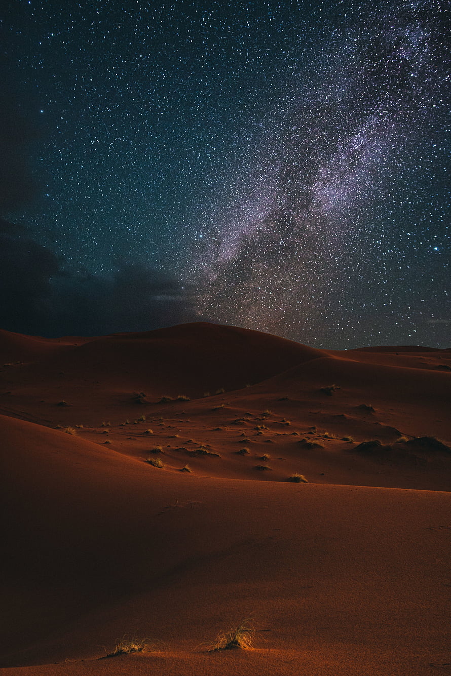 Milky Way Galaxy Arching Over Red Desert Dunes Under a Starry Night Sky HD phone wallpaper