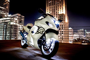 White Suzuki Hayabusa Sport Bike Parked on Rooftop at Night with City Skyline HD wallpaper