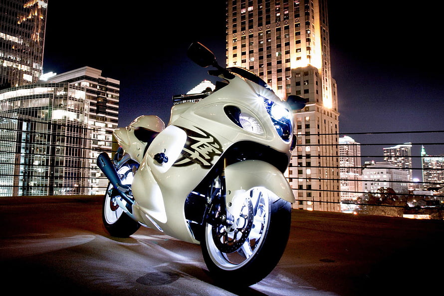 White Suzuki Hayabusa Sport Bike Parked on Rooftop at Night with City Skyline HD wallpaper