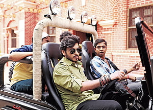 Munna Bhaiya in a rugged 4x4 vehicle with crew in front of a red brick building HD wallpaper