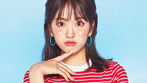 Ahn Yujin Portrait in Red Striped Top with Blue Hoop Earrings and Heart Cheek Makeup HD wallpaper