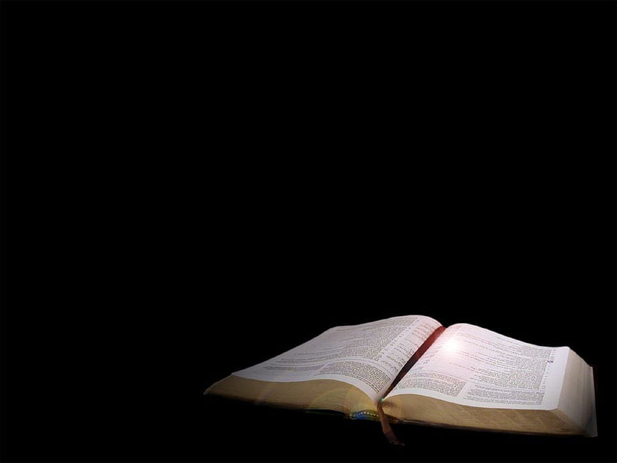 Open Bible with Illuminated Pages Against a Dark Background HD wallpaper