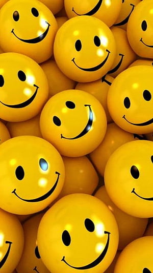 Glossy Yellow Smiley Face Balls Pile Up in a Bright and Cheerful Pattern HD phone wallpaper